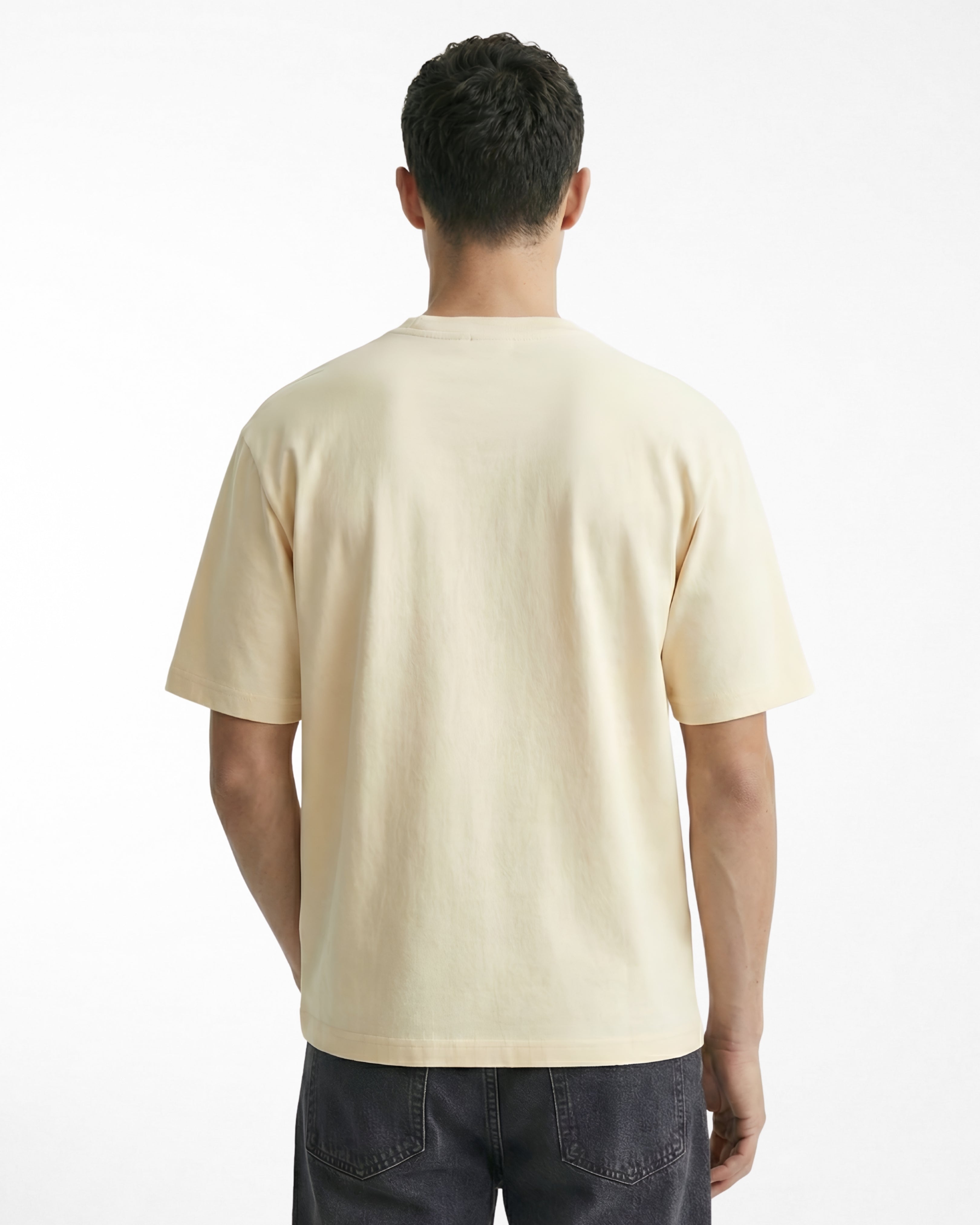 man wearing relaxed fit cream tshirt