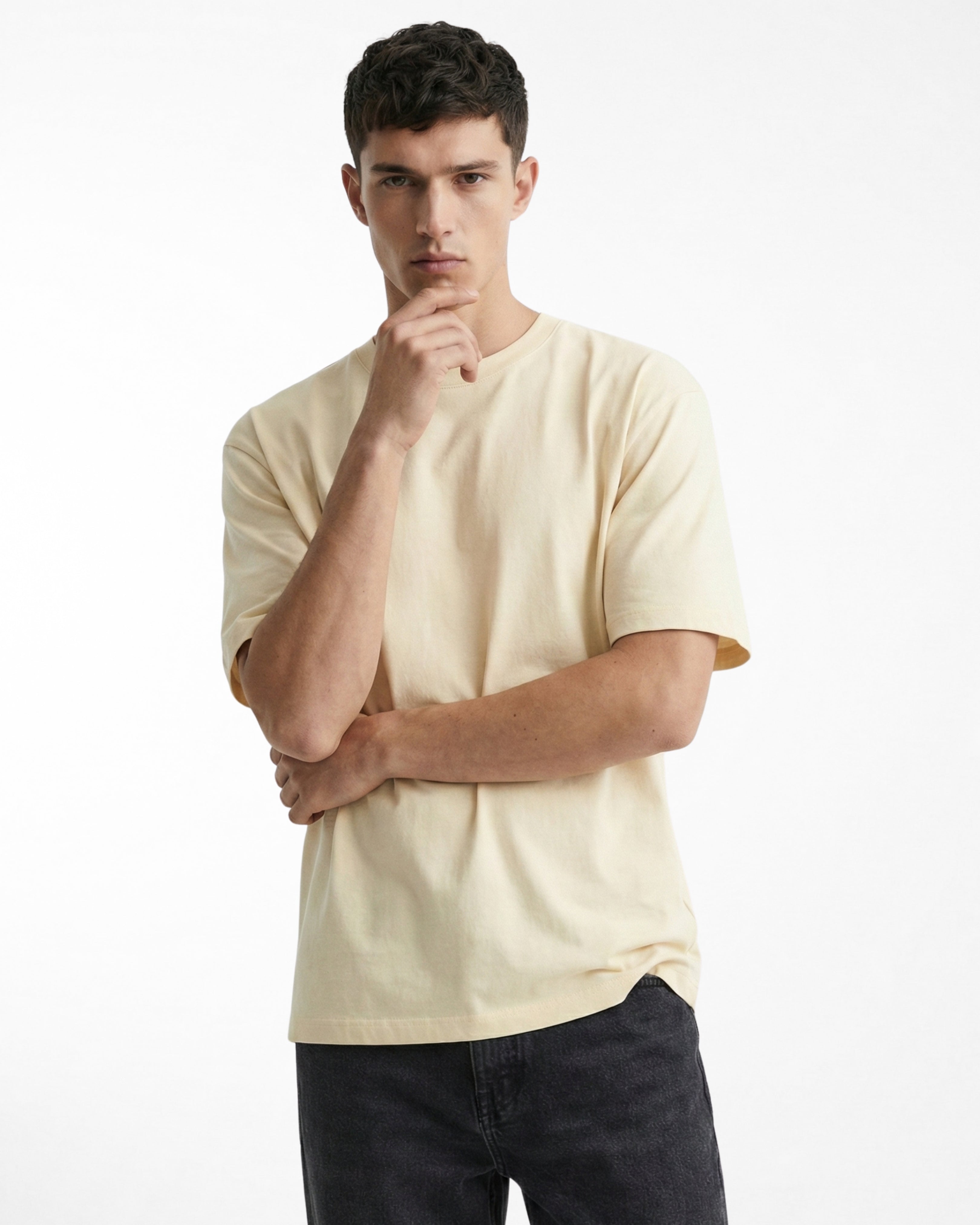 man wearing relaxed fit cream tshirt