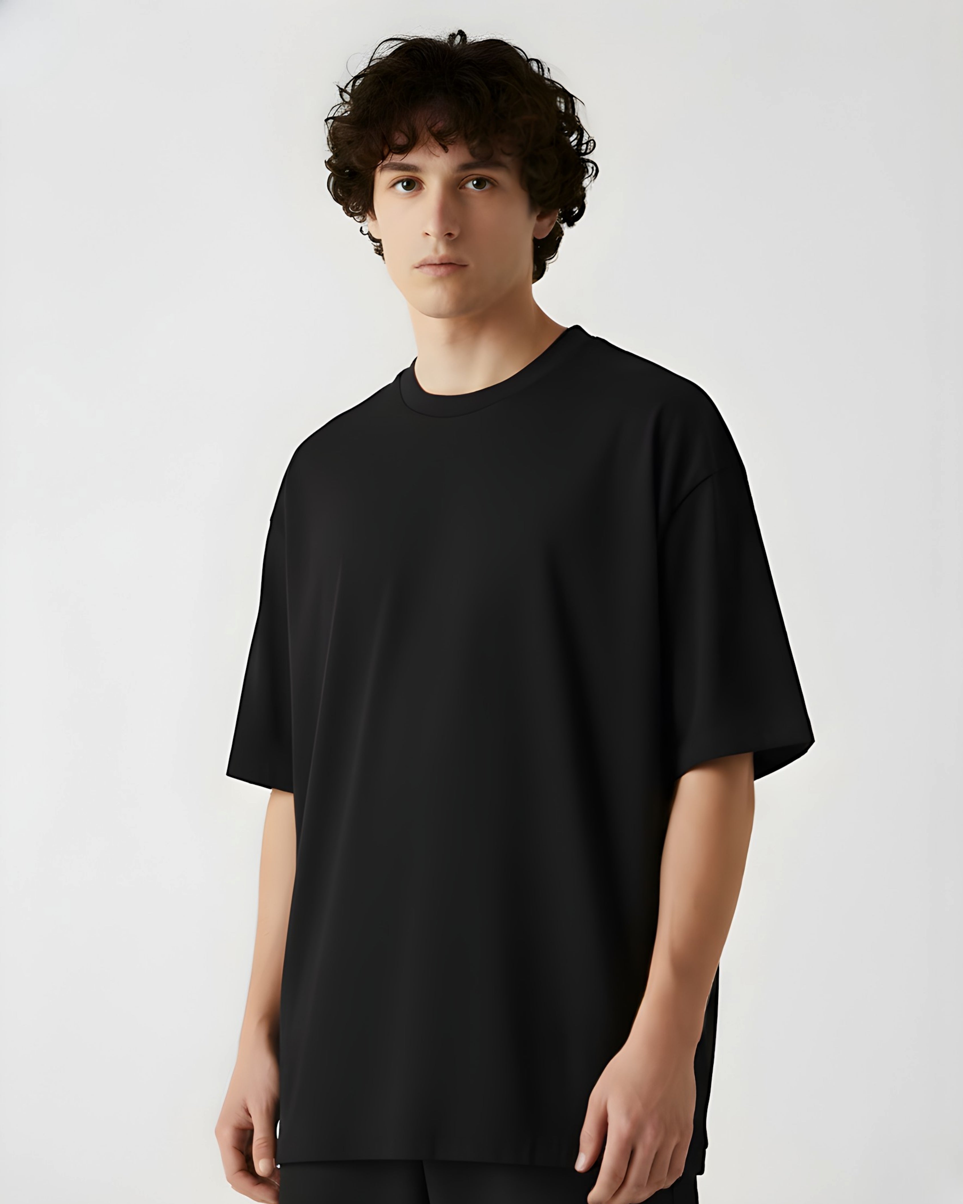 Person wearing a black t-shirt against a white background