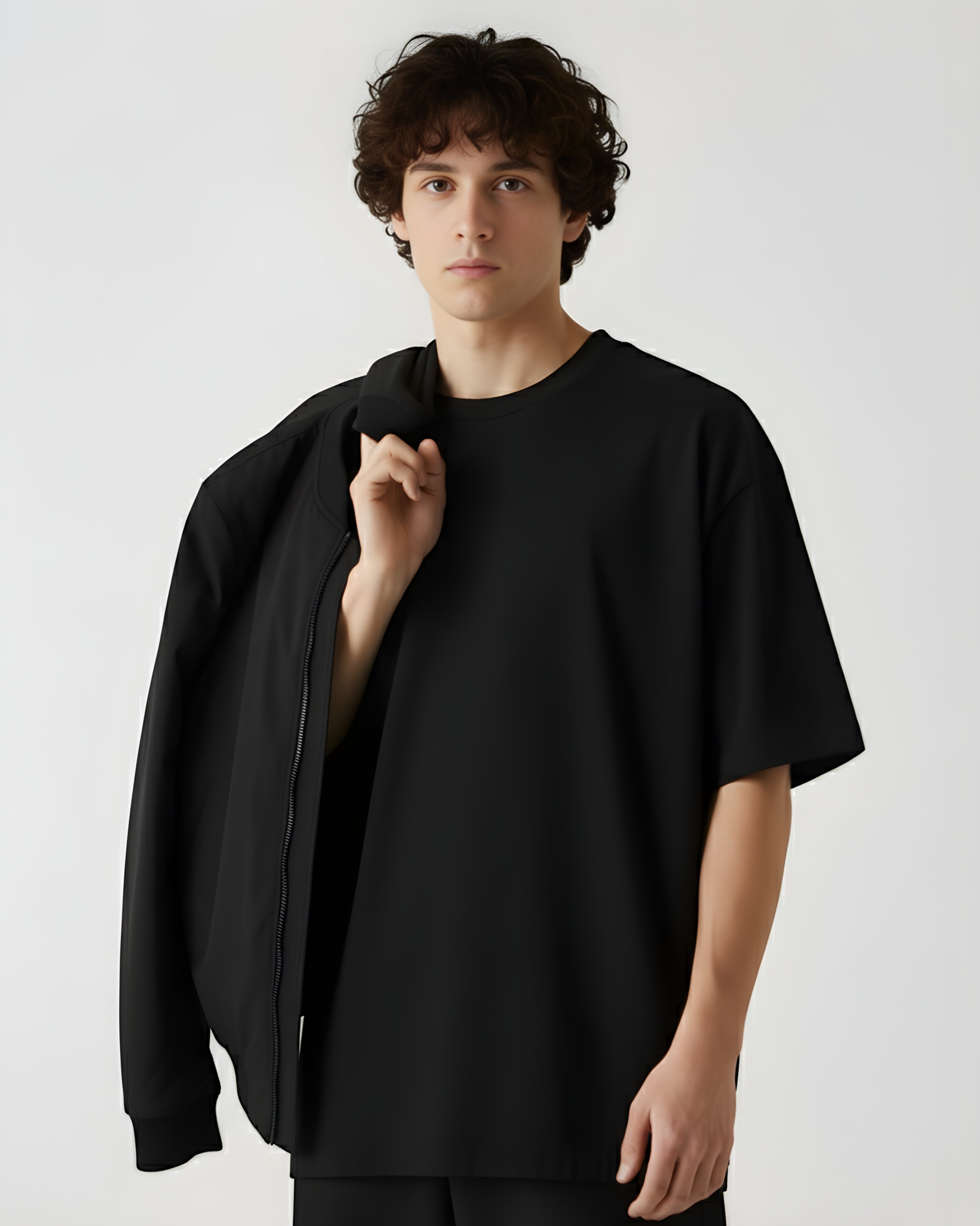 Person wearing a black outfit against a white background
