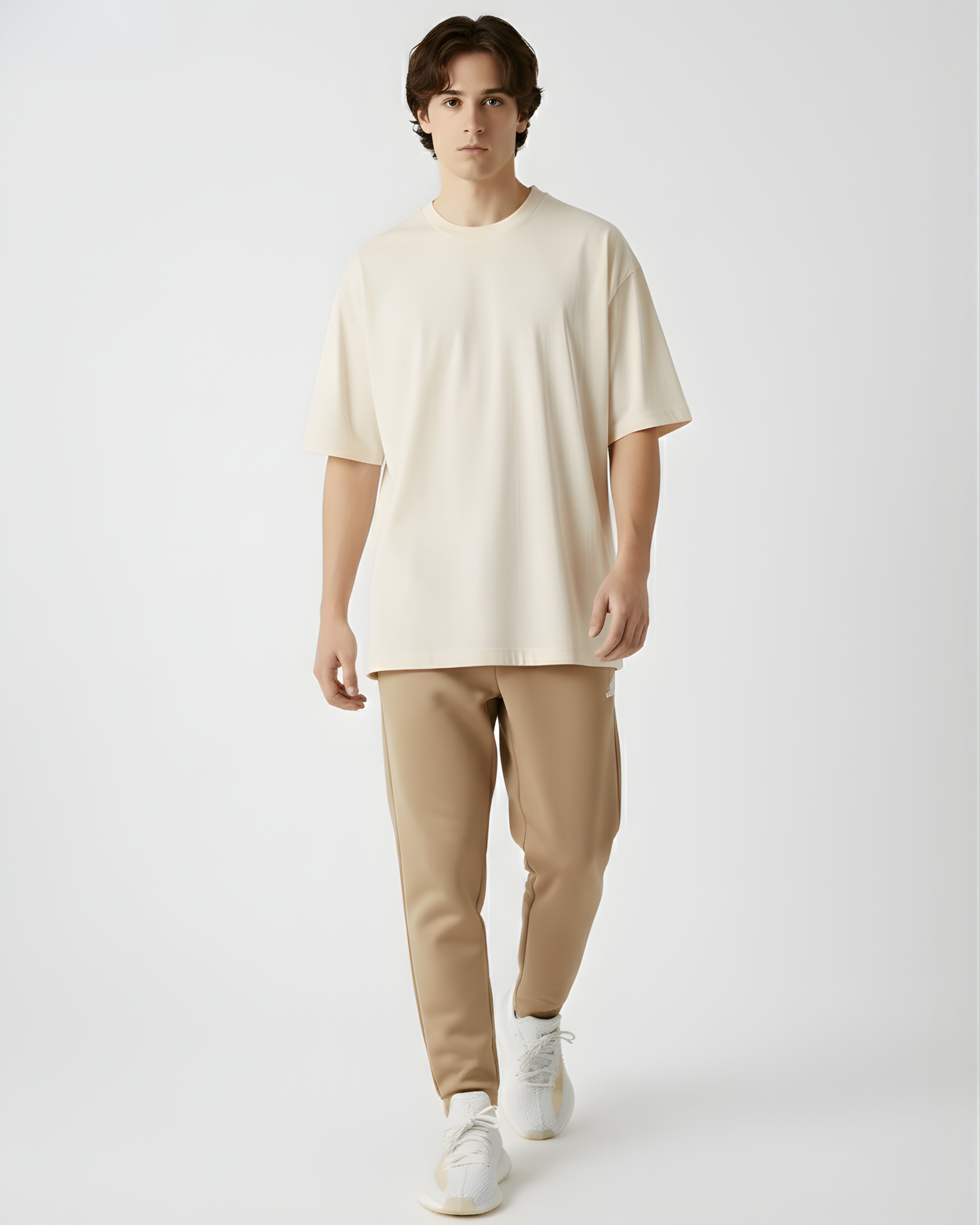 Person wearing a cream  tshirt against a plain background