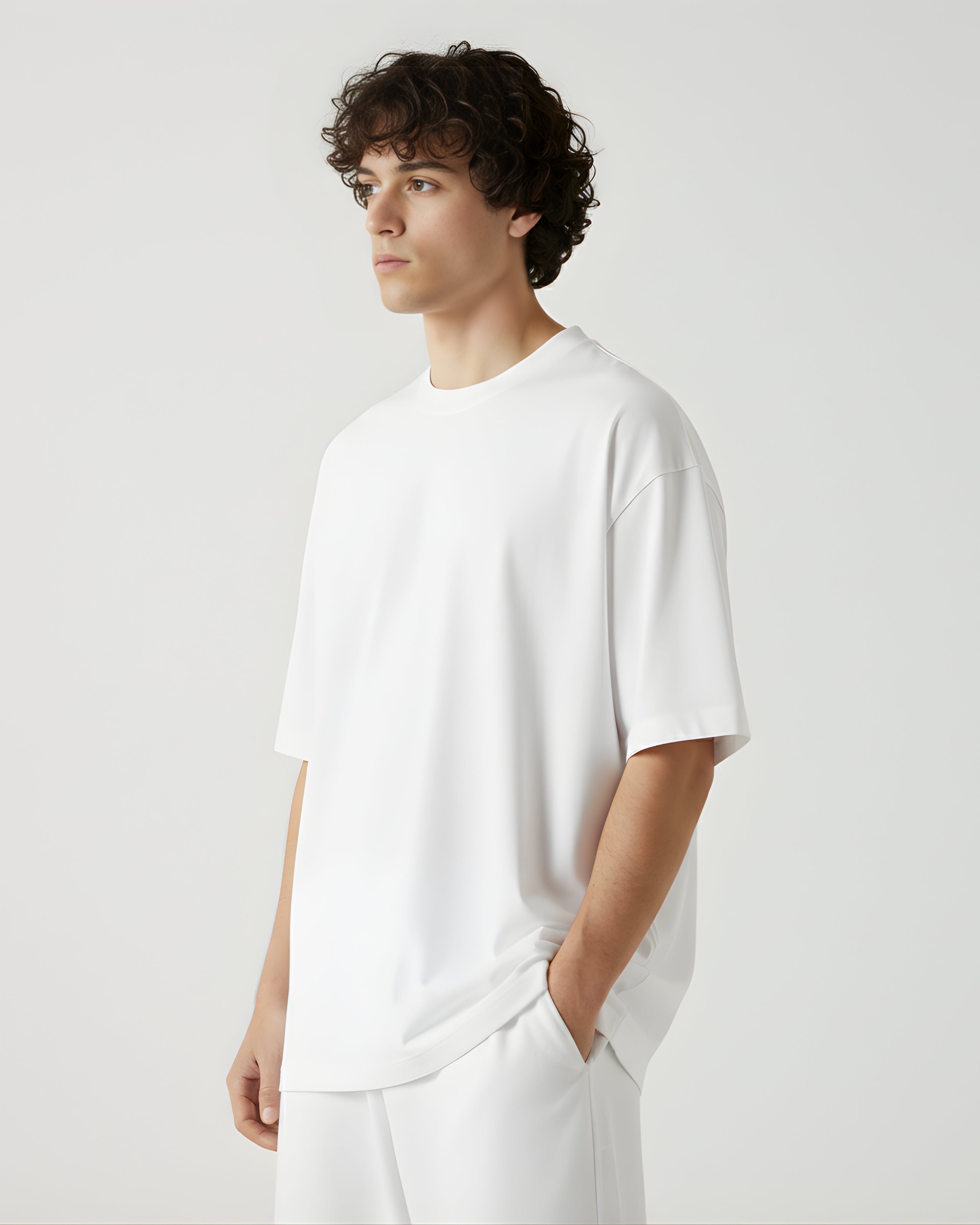 Person wearing a white oversize tshirt on a white background
