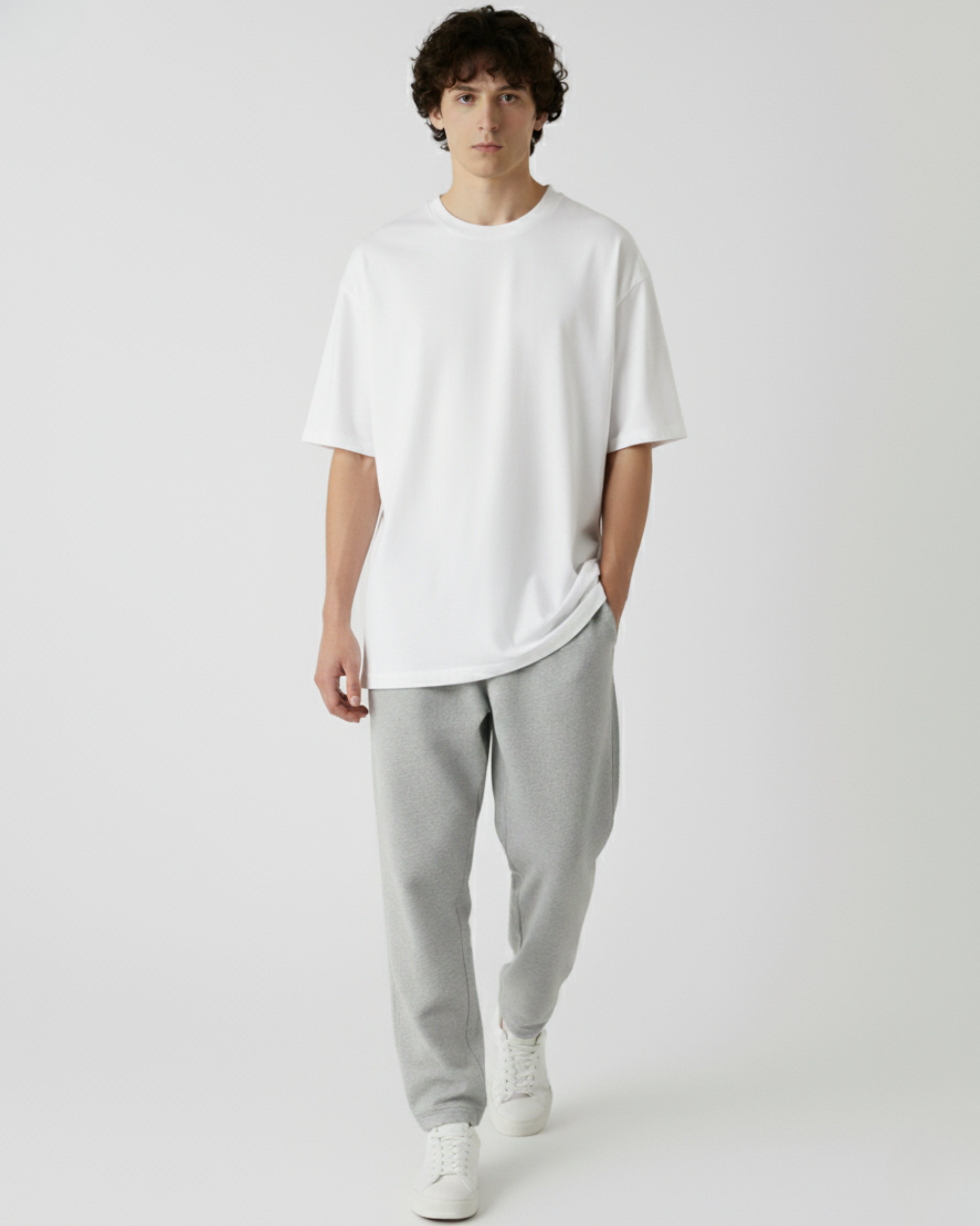 Person wearing a white oversize tshirt on a white background