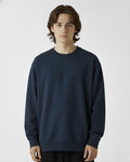 Person wearing a navy blue sweatshirt on a white background