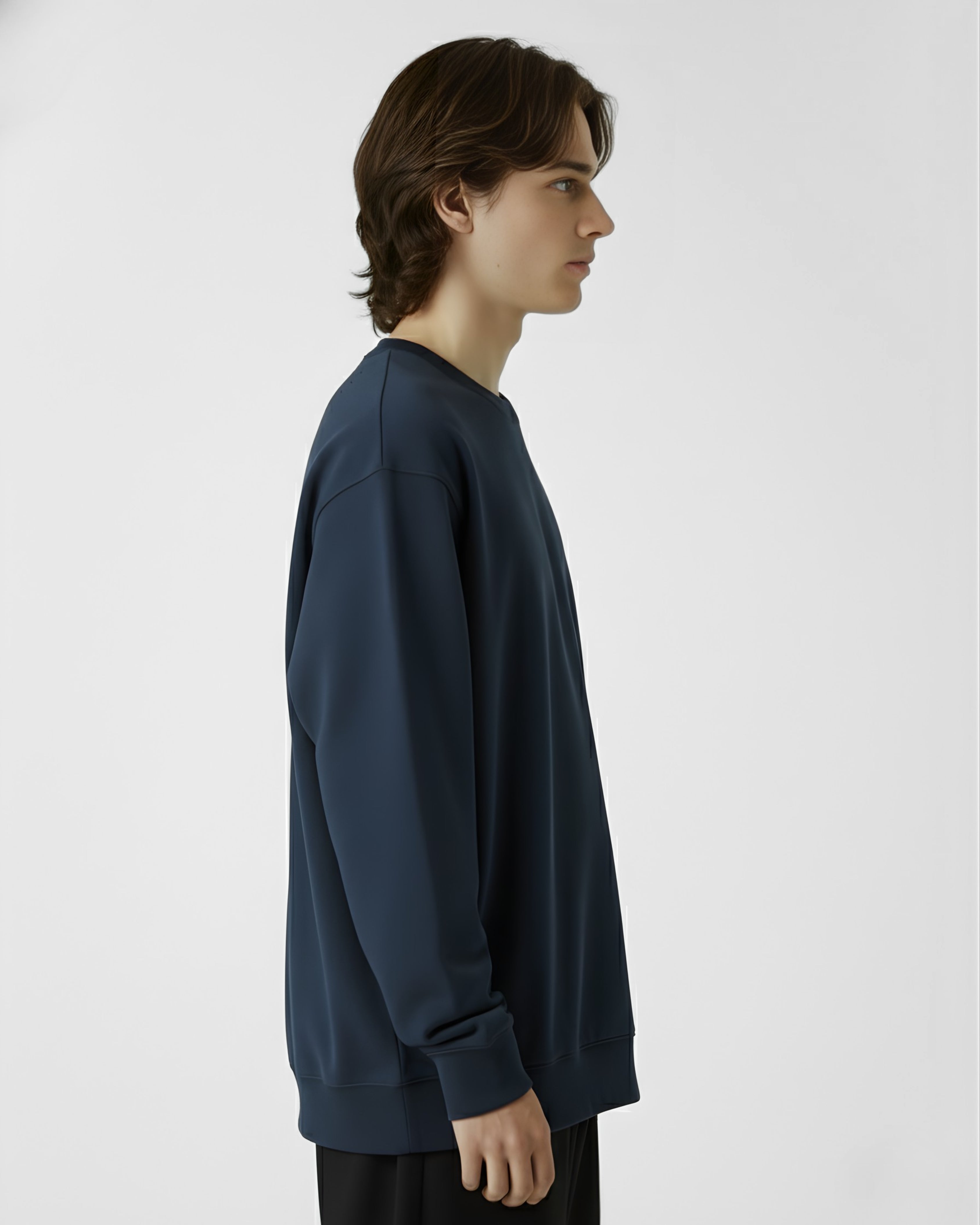 Person wearing a dark blue long-sleeve shirt against a white background