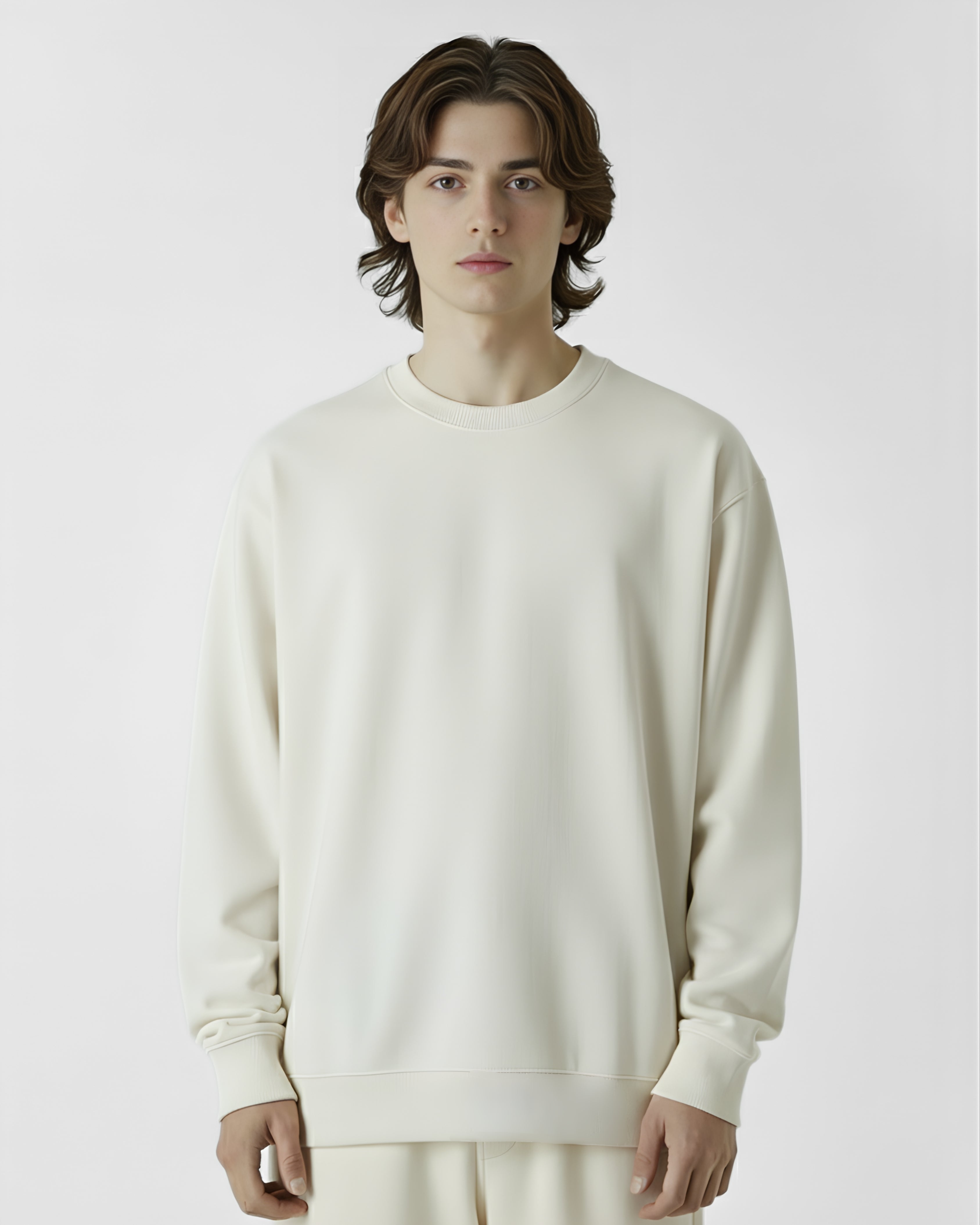 Person wearing a cream-colored sweatshirt against a plain background